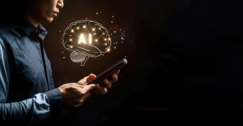 Man holding smartphone with hologram brain and glowing AI text showing AI technology concept