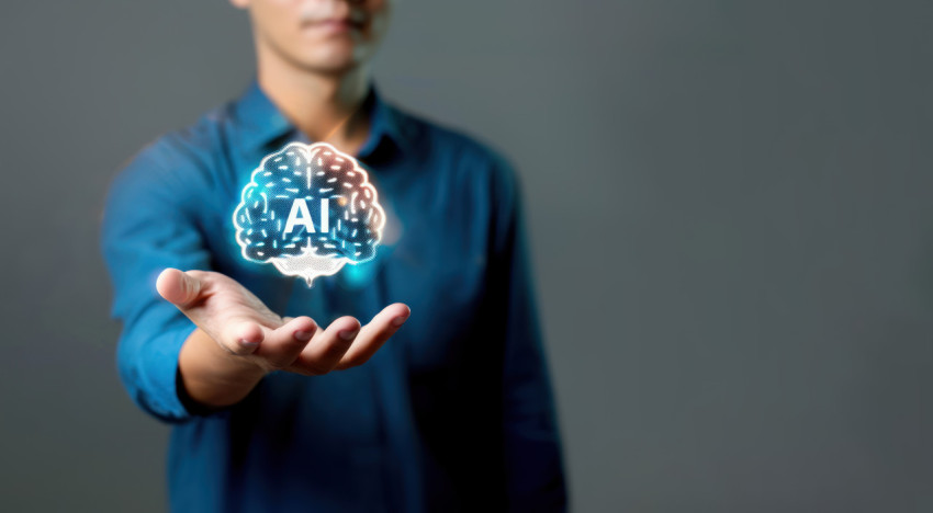 Man holding digital brain with AI text floating above showing AI technology and innovation concept