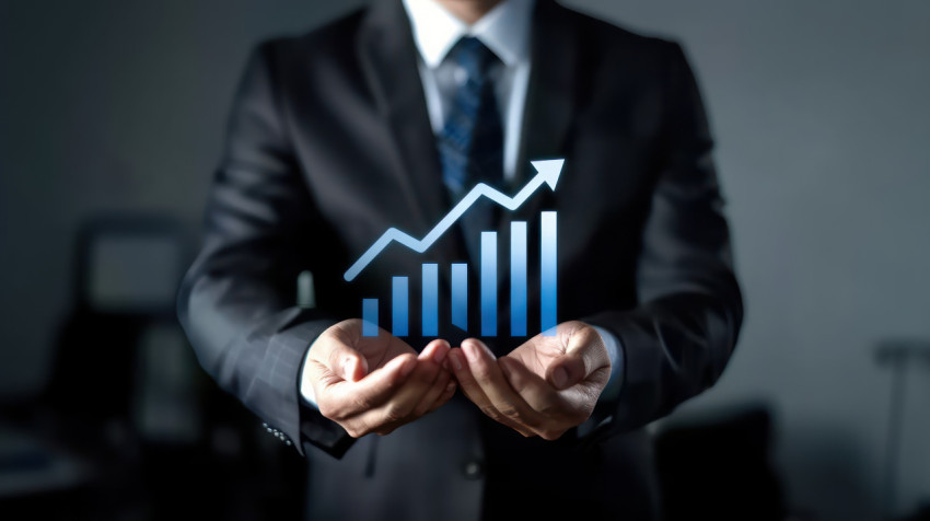 Businessman holding growth graph icon illustrating sales performance improvement