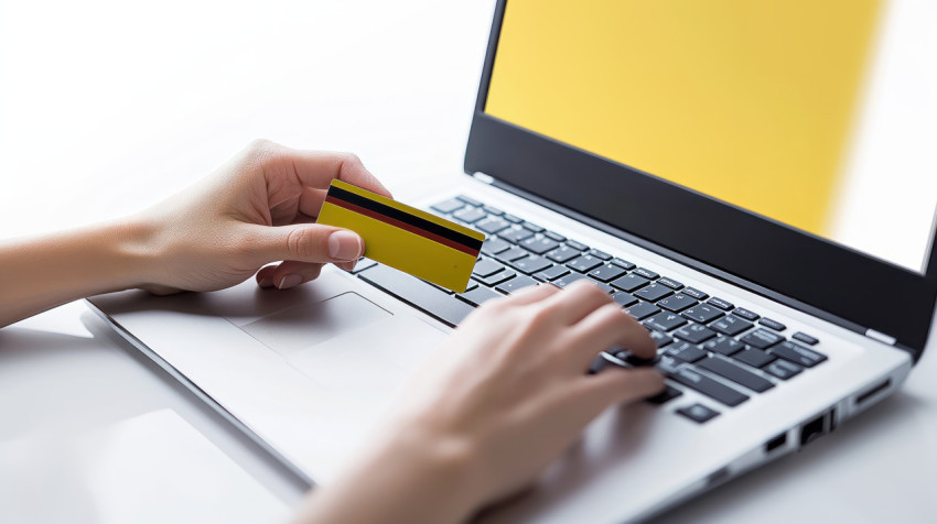 A person holding a credit card while typing their laptop an online shopping concept