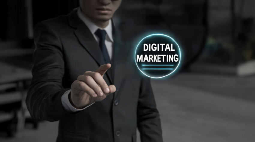 A businessman reaching out to touch a digital marketing icon with the text DIGITAL MARKETING floating in the air