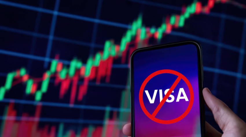 Hand holding a phone displaying visa text on the screen symbolizing a visa denial process