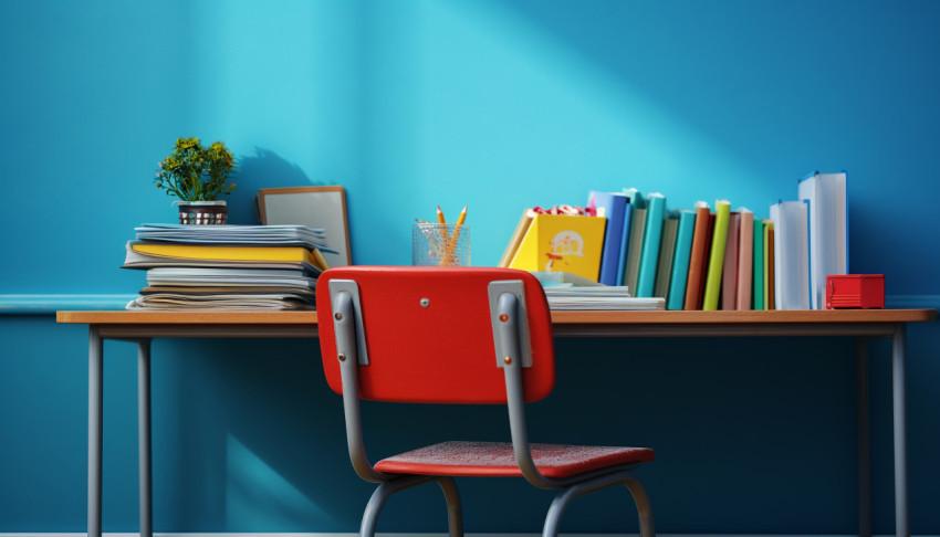 School Supplies and Textbooks on a Blue Desk