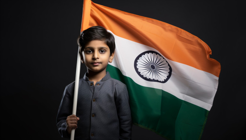 The young boy is holding an indian flag