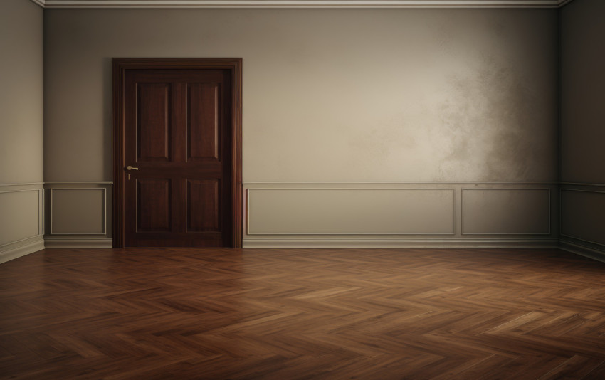 Inside a room with white walls wooden floors and a closed door