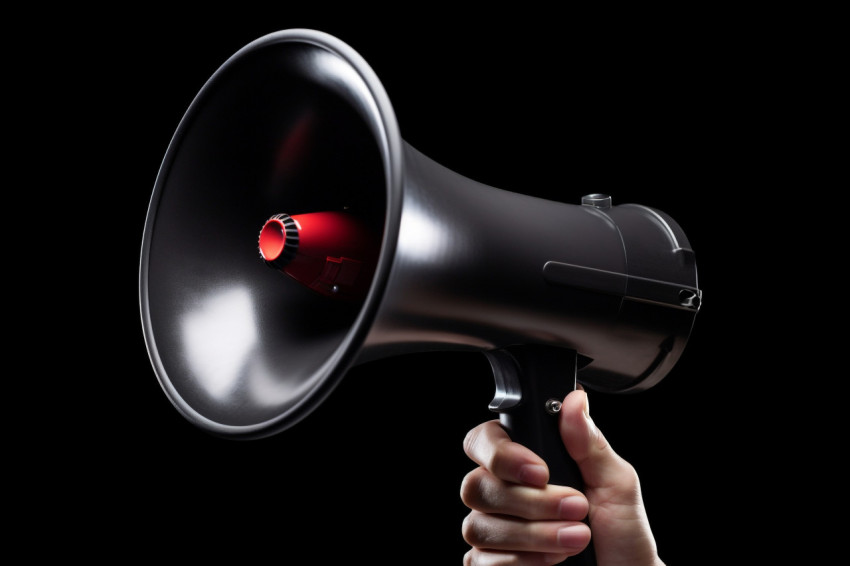 A hand gripping a black megaphone