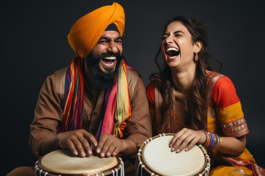 Indian couple in traditional attire dancing playing drum on a white background