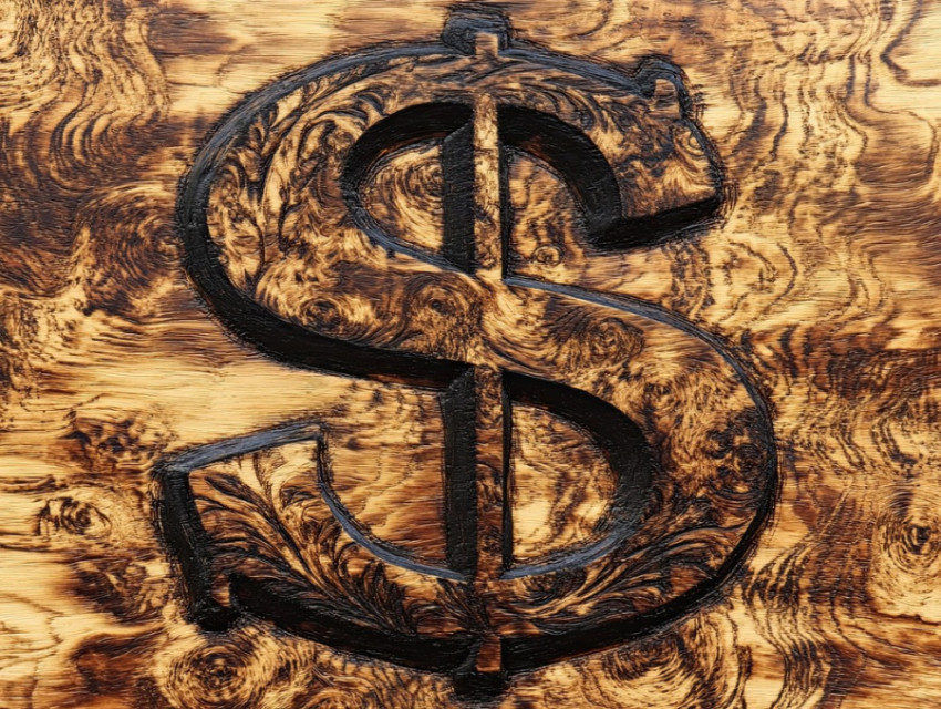 Burned dollar sign on wood