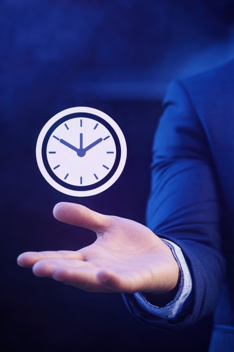 Businessman holding out his hand with clock icon representing time management