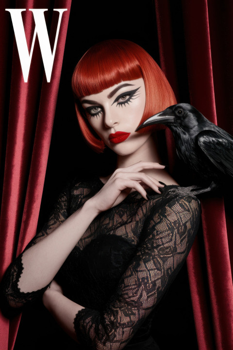 Petite model in crimson gothic style with raven on shoulder