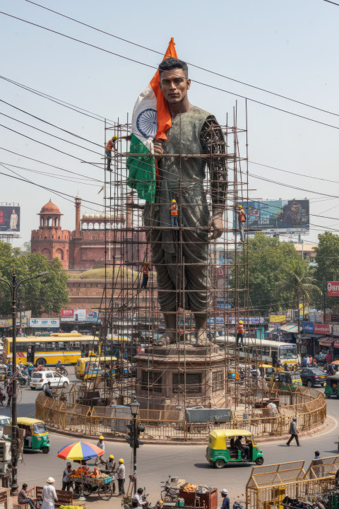 Giant statue ai prompt for google gemini nano banana of indian man holding flag Giant statue ai prompt for google gemini nano banana of indian man holding flag