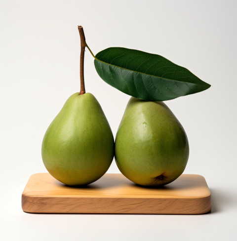 two avocados on a wooden board on white background