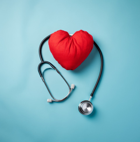 Heart and stethoscope on blue background