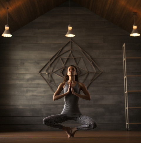 Woman stretches in yoga studio